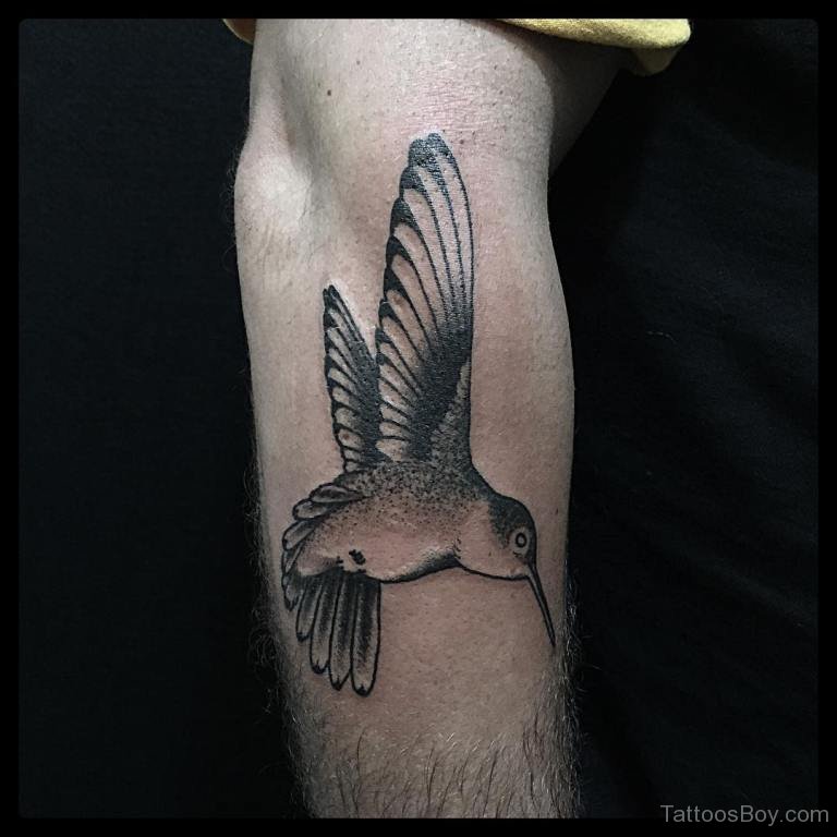 Hummingbird tattoo on the left tricep.